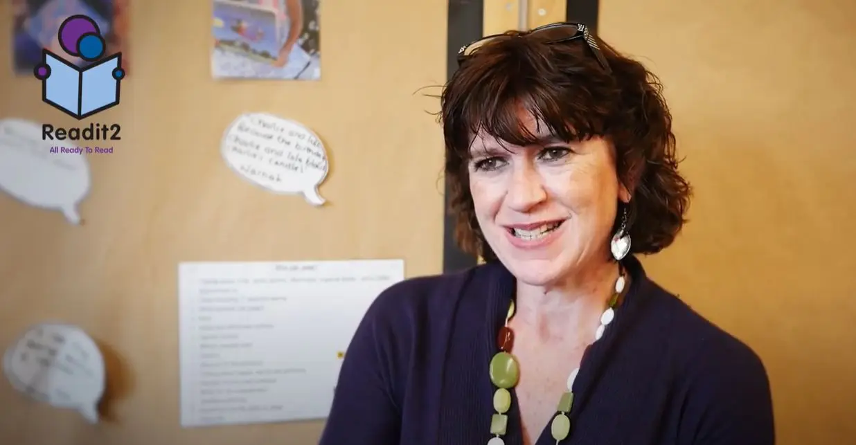 A woman with short hair and wearing a necklace.