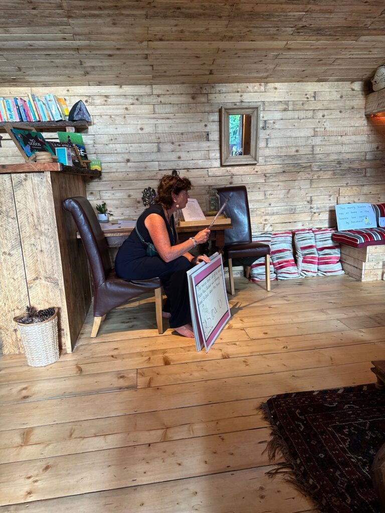 A woman sitting on top of a chair reading.