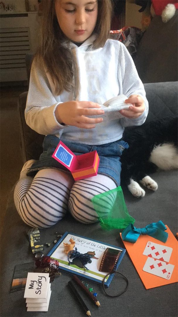 A girl sitting on the couch playing wii