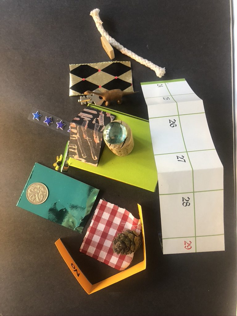 A table with various items on it including a knife, scissors and a box.