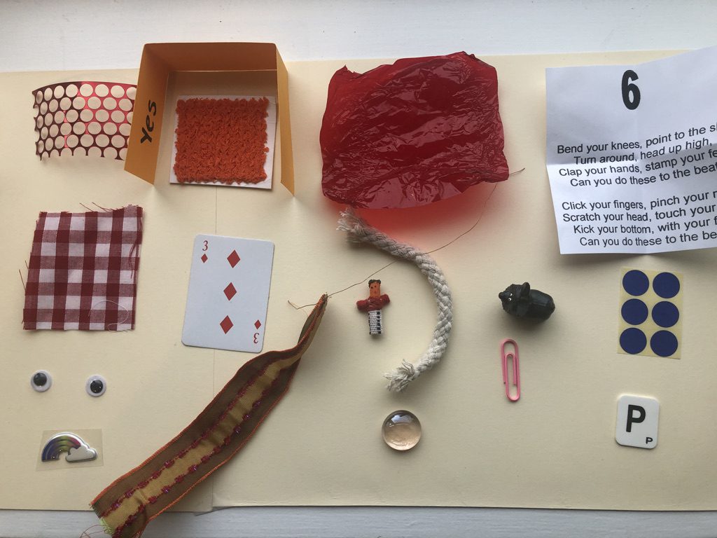 A table with various items on it including scissors, buttons and other objects.