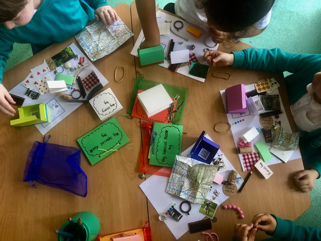 A group of people sitting around a table with papers and other items.