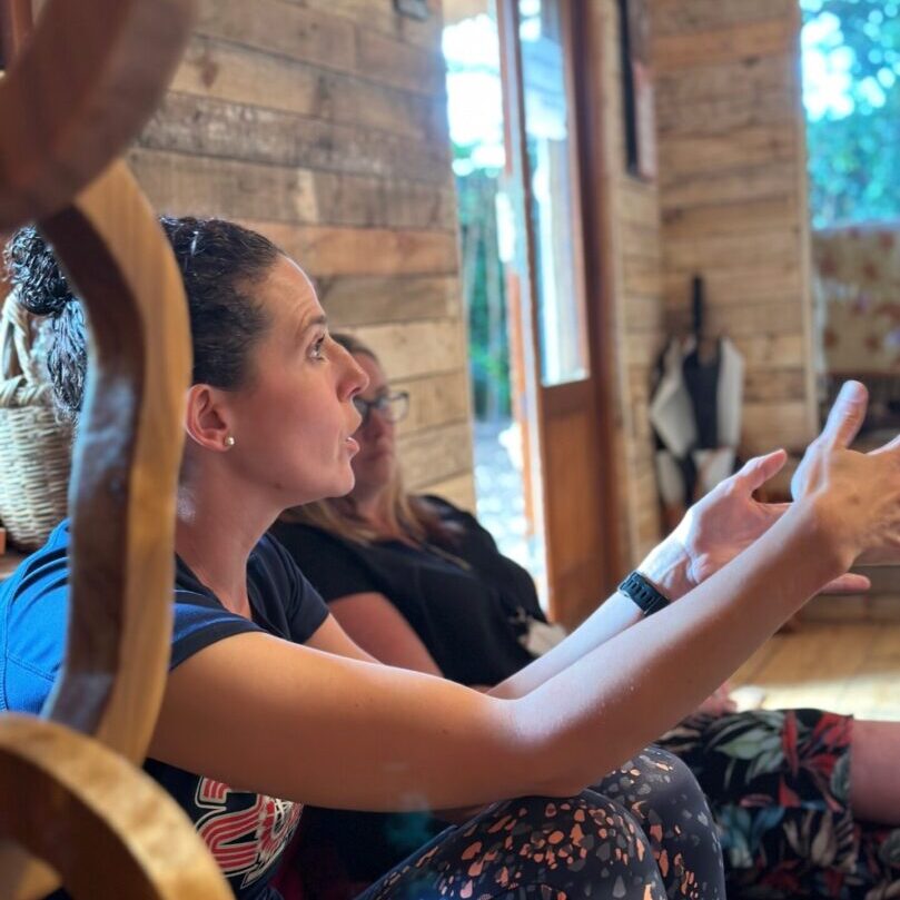 Two women sitting on a couch looking at an ipad.