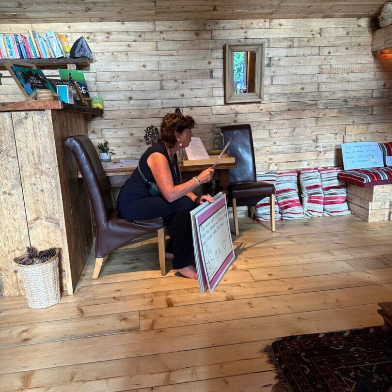 A woman sitting on top of a chair reading.